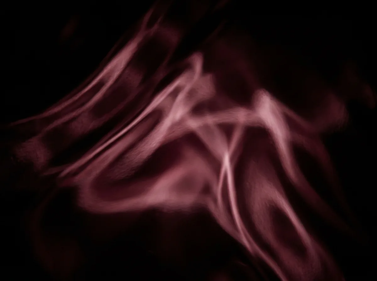 Abstract burgundy light through dark glass