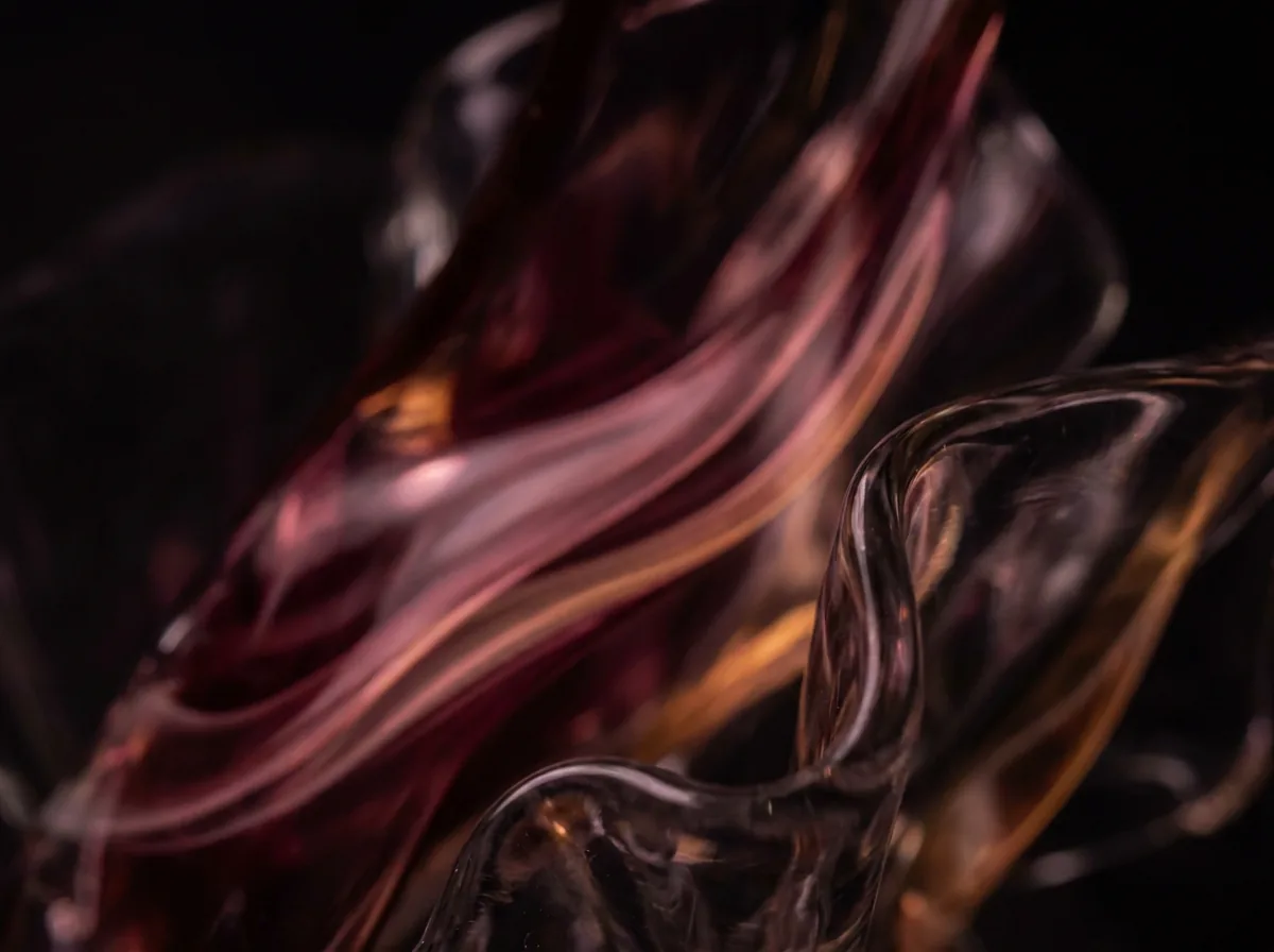 Abstract burgundy light through dark glass